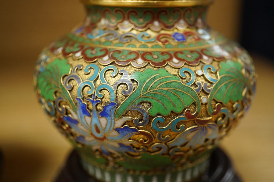 A pair of Chinese cloisonné enamel jars and covers on stands, 14cm high. Condition - good